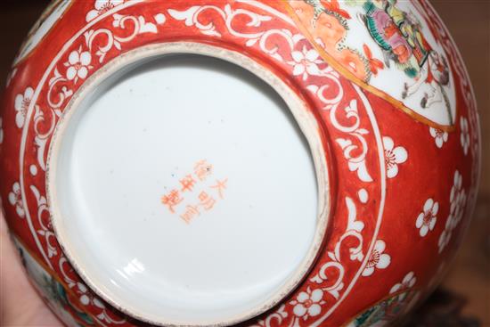 A Chinese porcelain bowl, decorated with figures in reserves on an iron red ground and two other items,